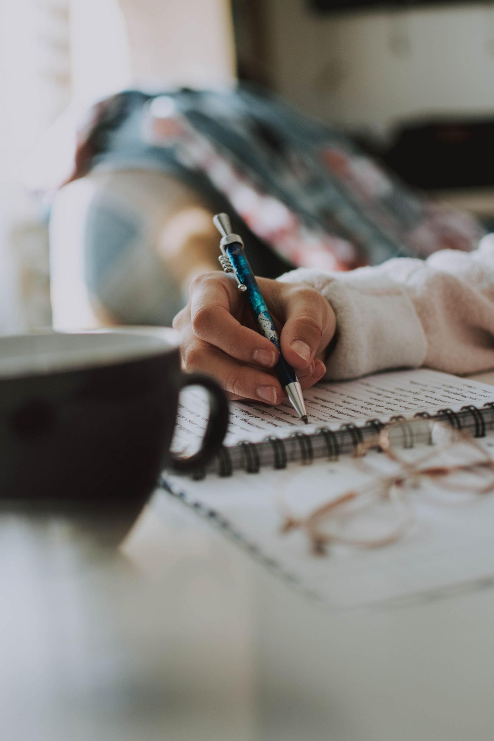 woman journalling about imposter syndrome in chronic illness